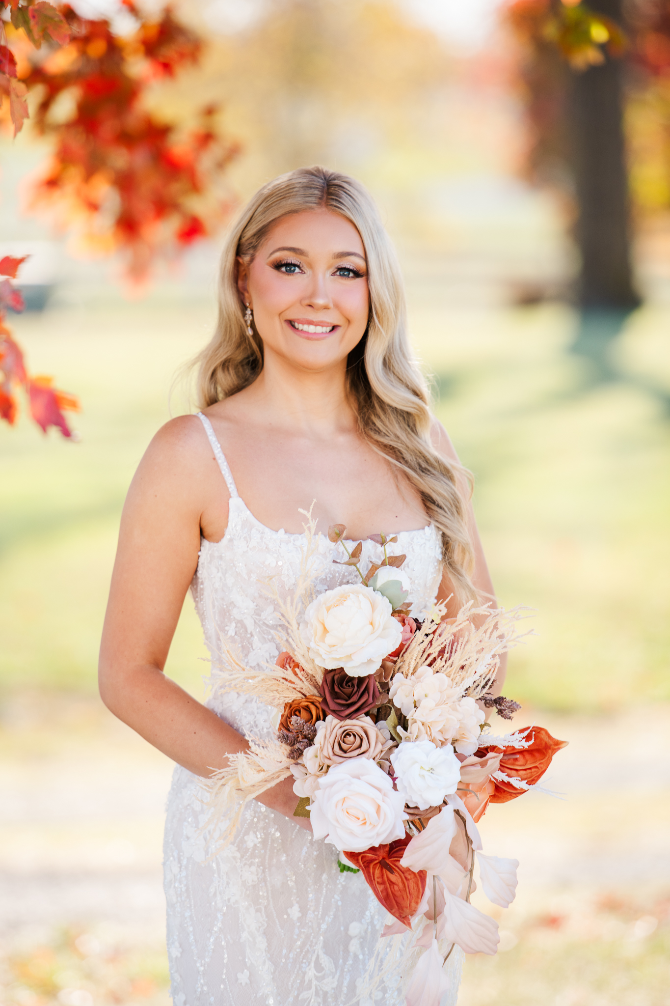 Bride portrait holding fall bouquet at Bluebird Manor wedding