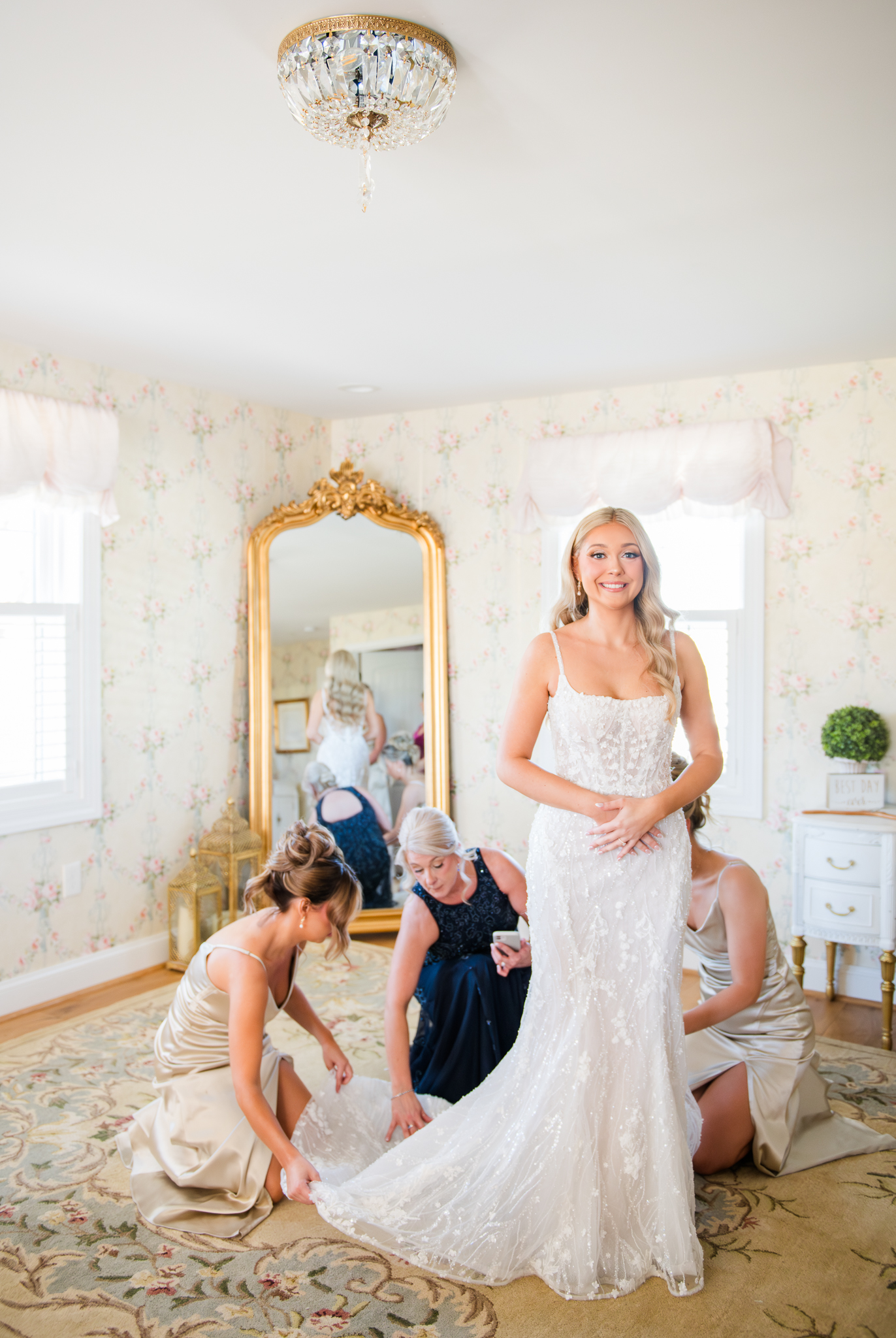 Bridesmaids helping the bride get ready on the morning of her Bluebird Manor wedding