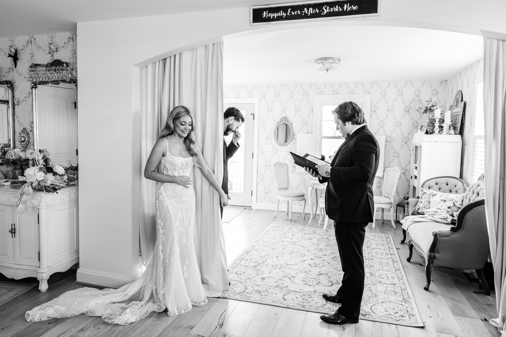 Emotional black and white image of a bride and groom sharing their first touch at Bluebird Manor