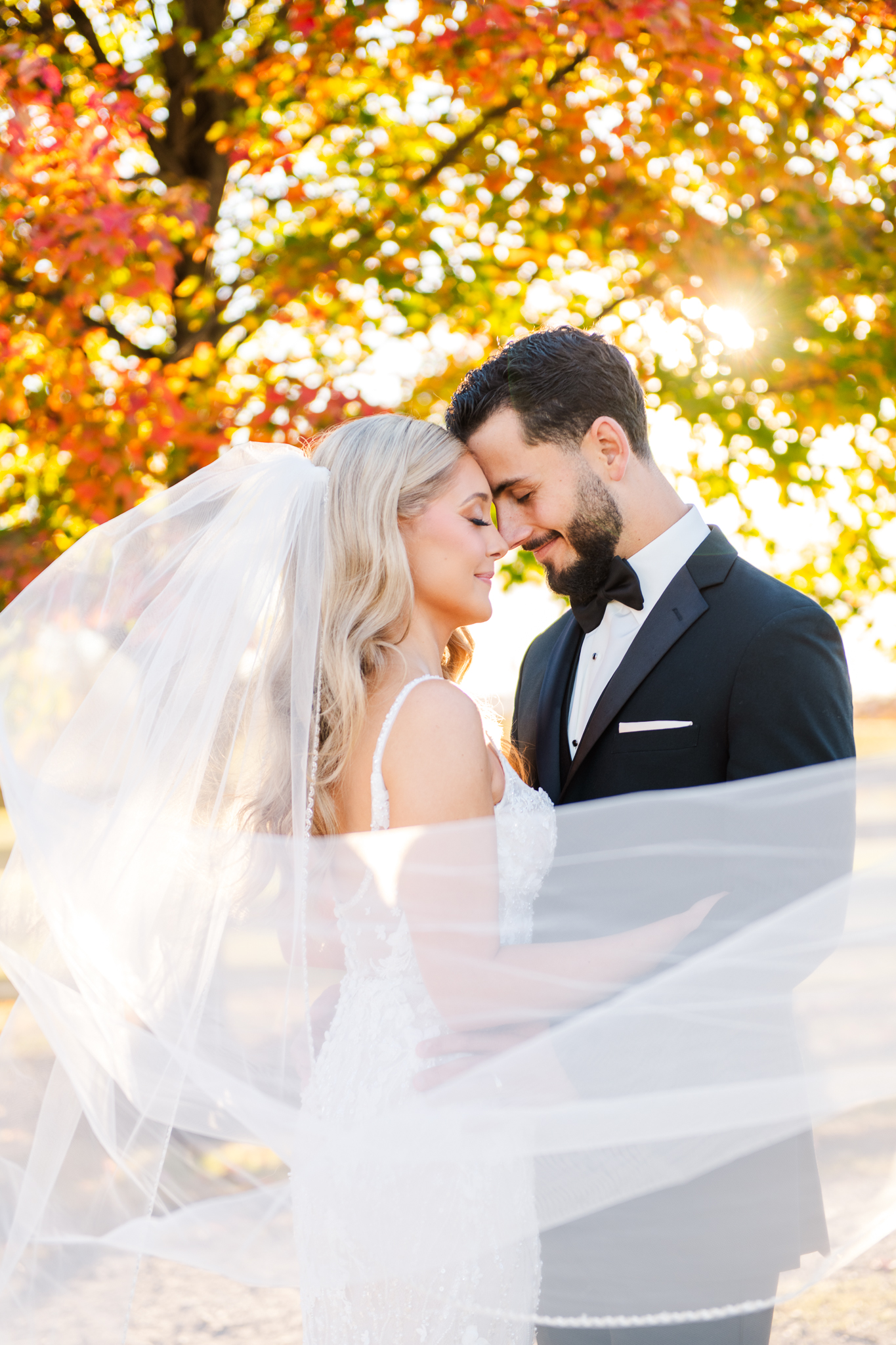 Bride and groom portrait with fall foliage at Bluebird Manor