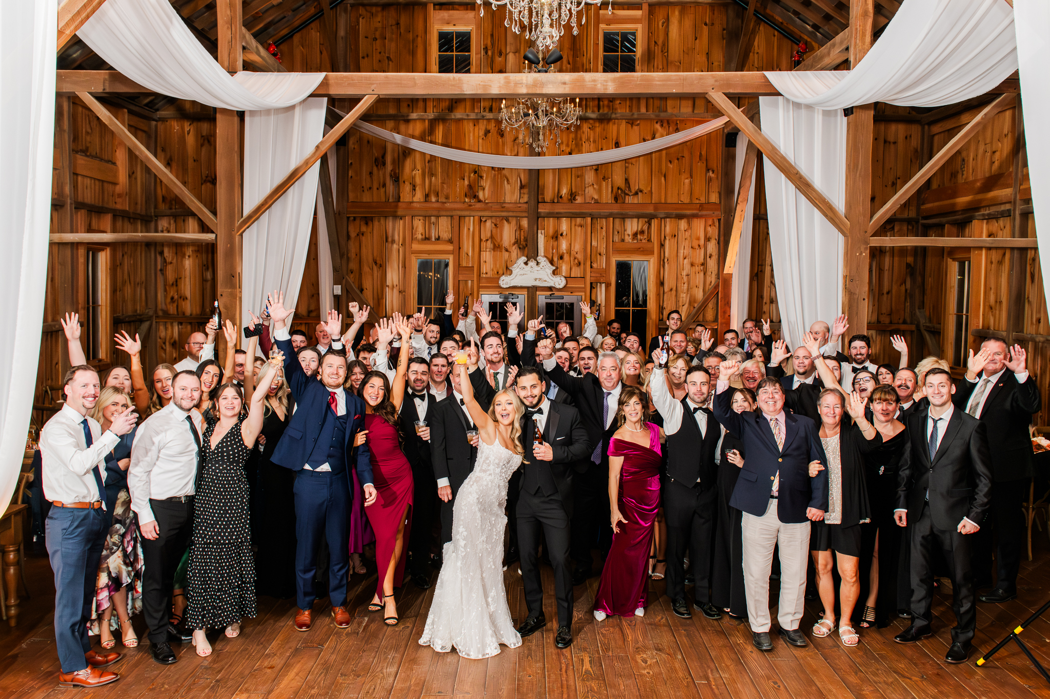 Large reception cheering portrait in Bluebird Manor's red barn