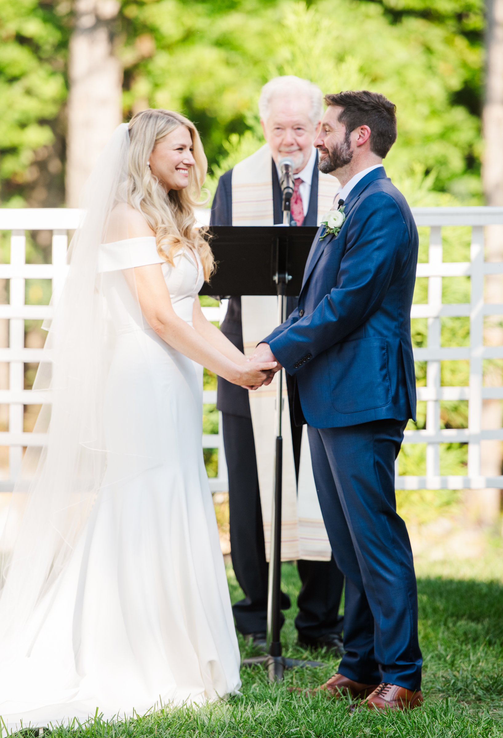 Bride and groom beam at each other during the ceremony