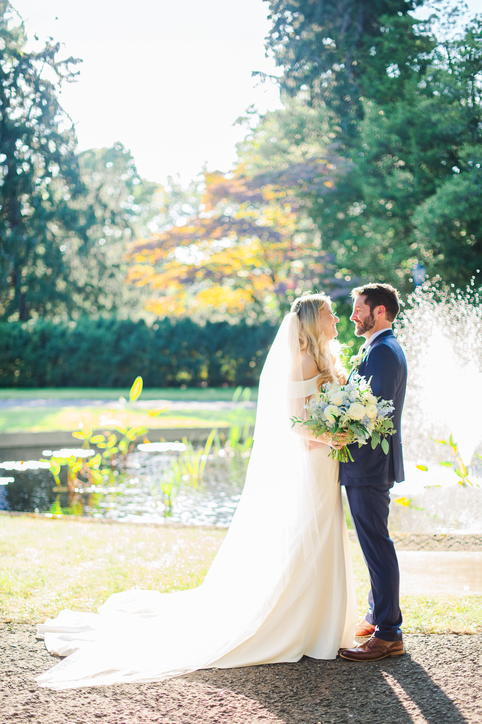 A romantic golden lit portrait in front of Strong Mansion's beautiful pond