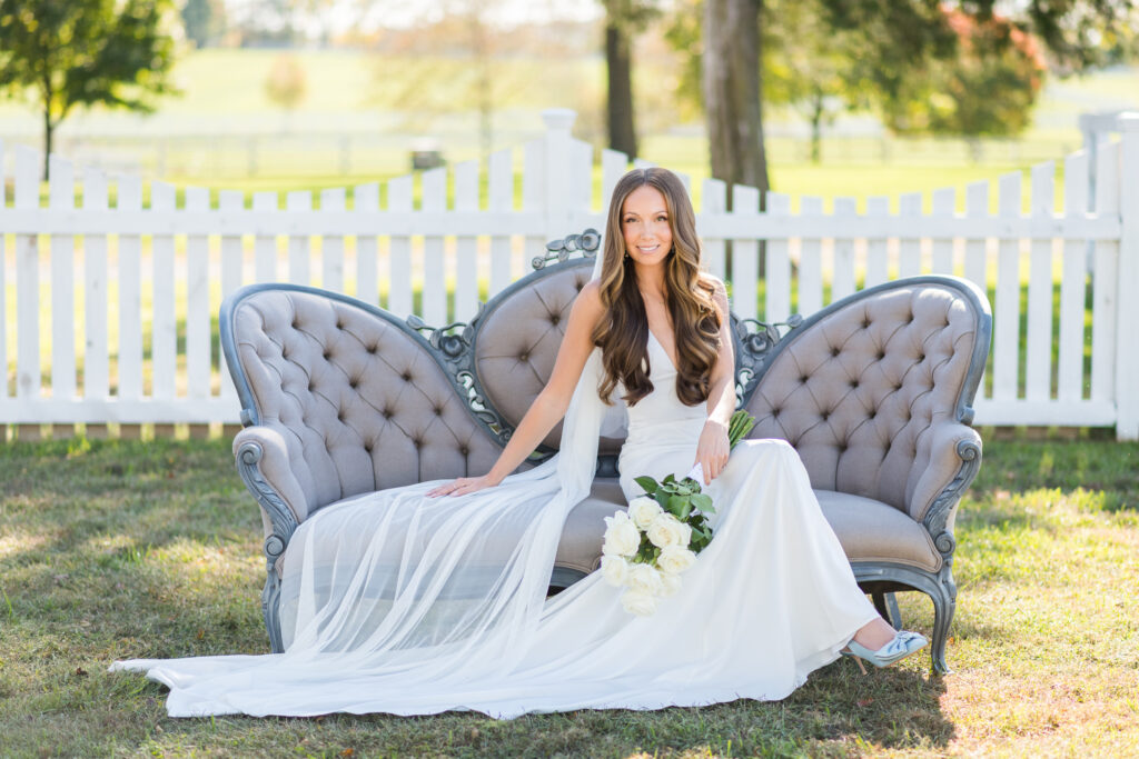 Bride sitting on vintage couch outside