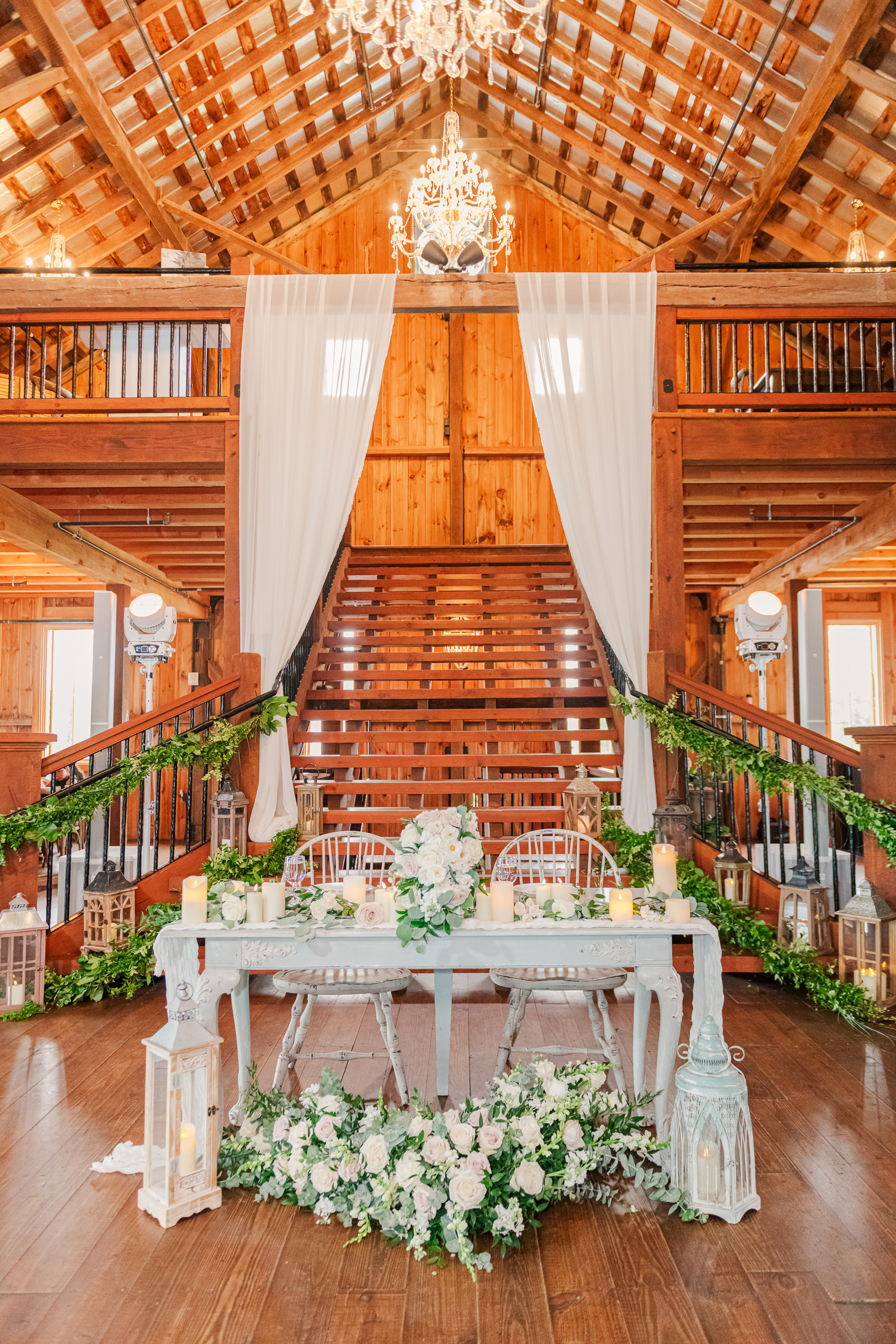 Bluebird Manor wedding reception grand staircase with draping and chandeliers