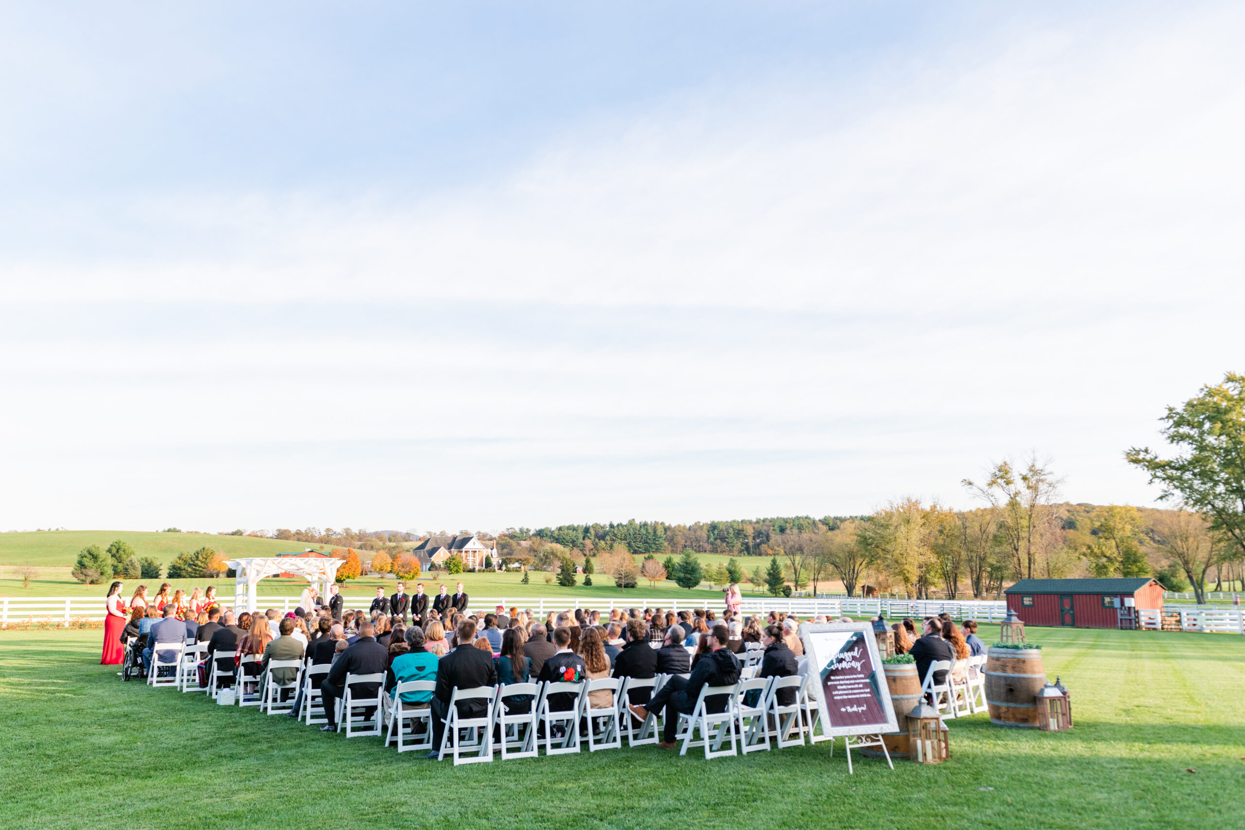 Wedding ceremony guests seated on lawn at Bluebird Manor