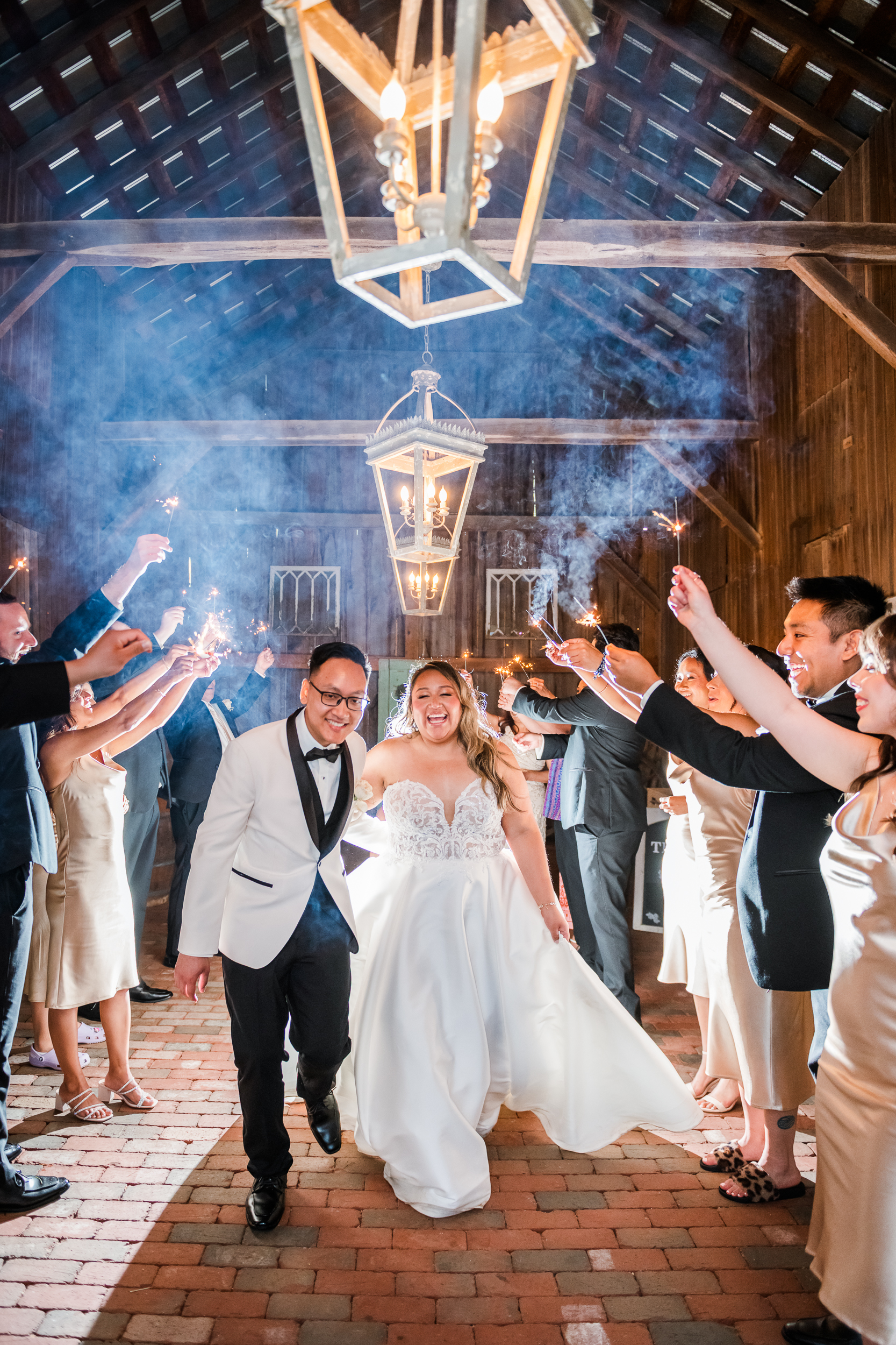 Bride and groom walking through sparkler exit 
