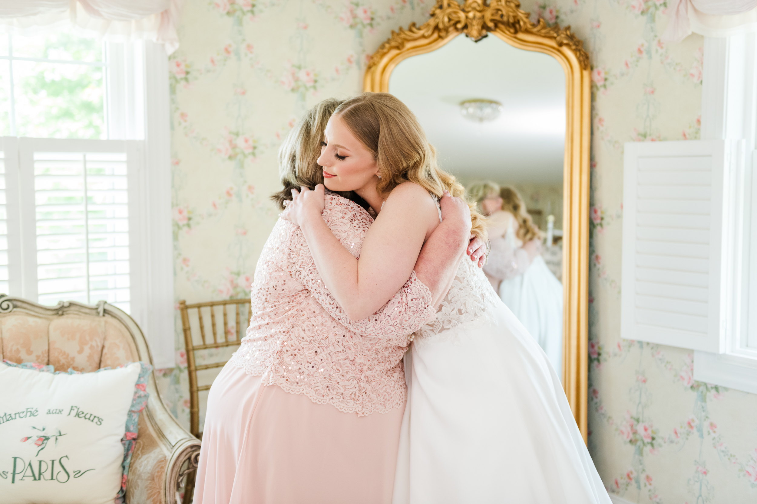 Bride hugs mom while getting ready at Bluebird Manor