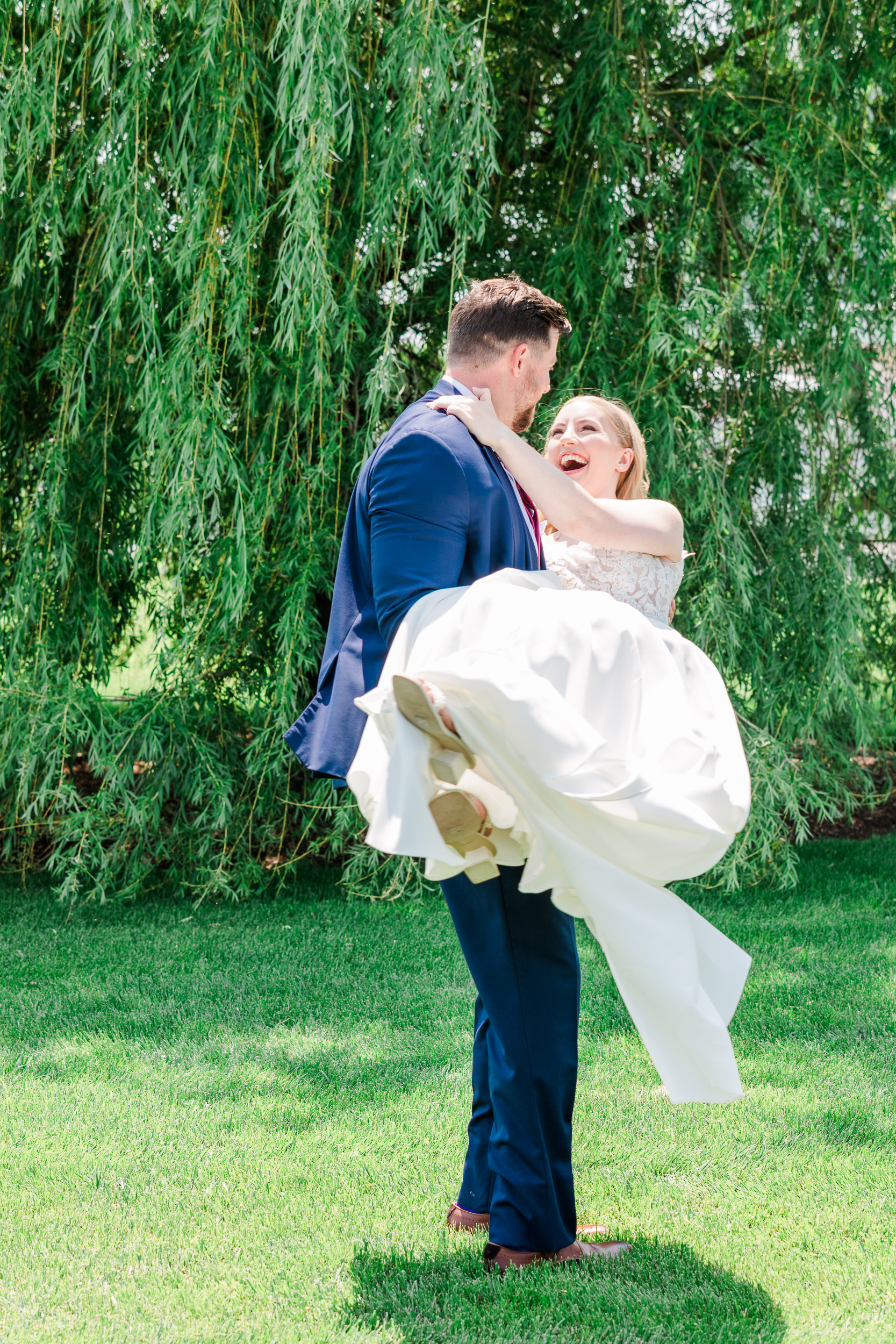 Romantic wedding portraits in front of Bluebird Manor's willow tree