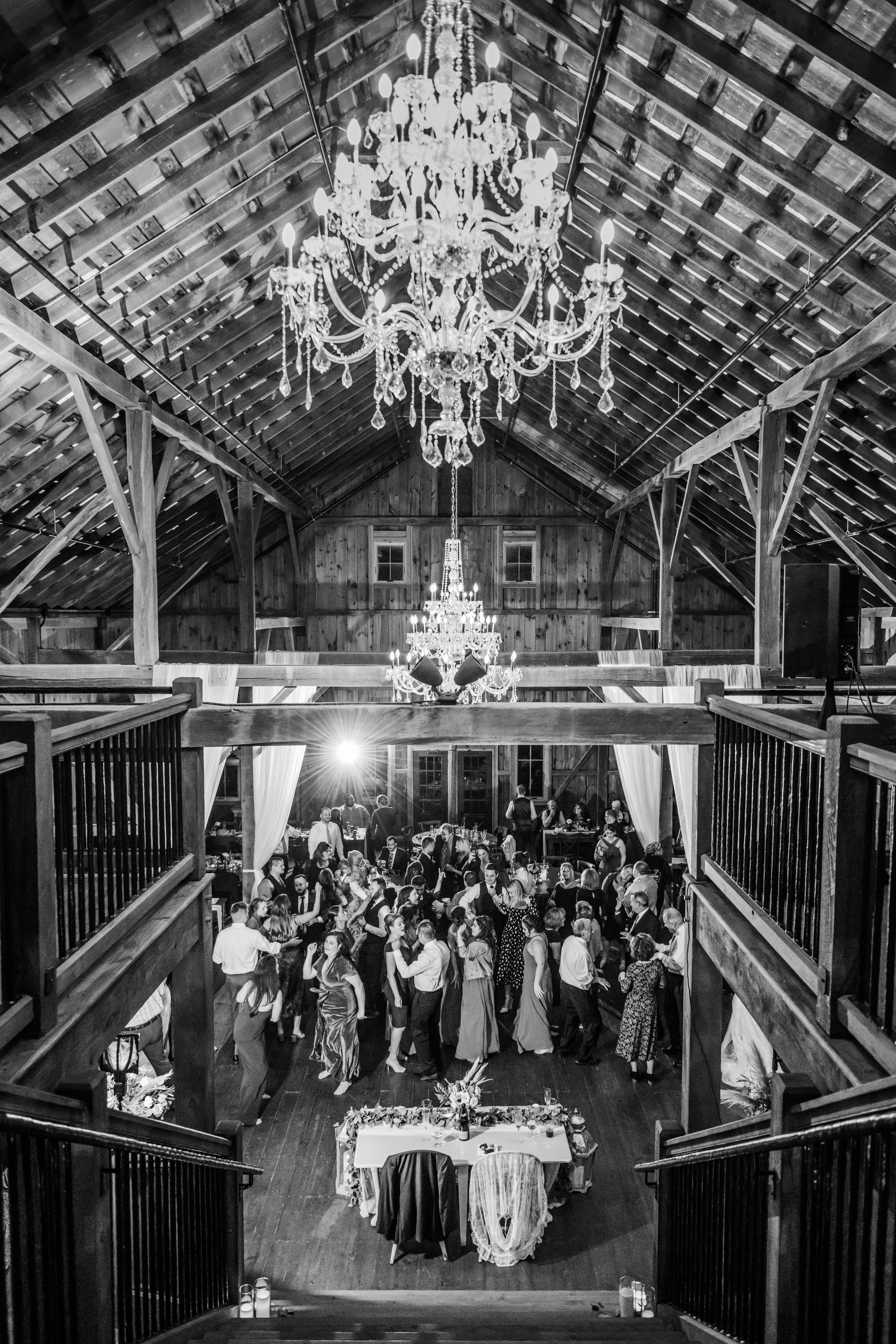 Wedding guests dancing under chandeliers 
