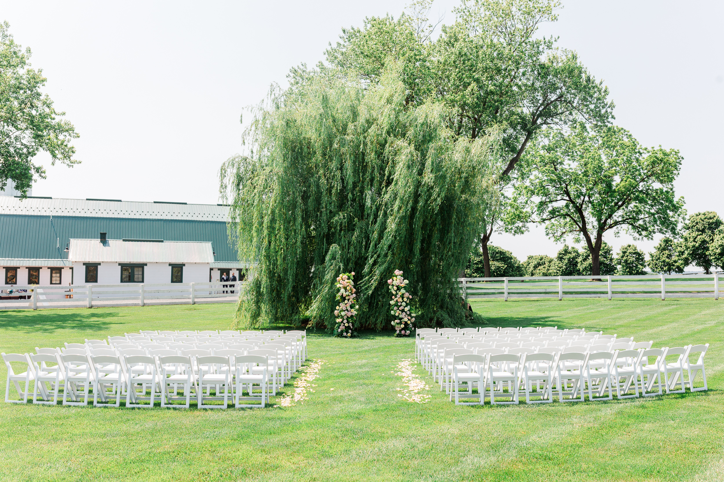 June wedding ceremony beneath the willow tree at Bluebird Manor