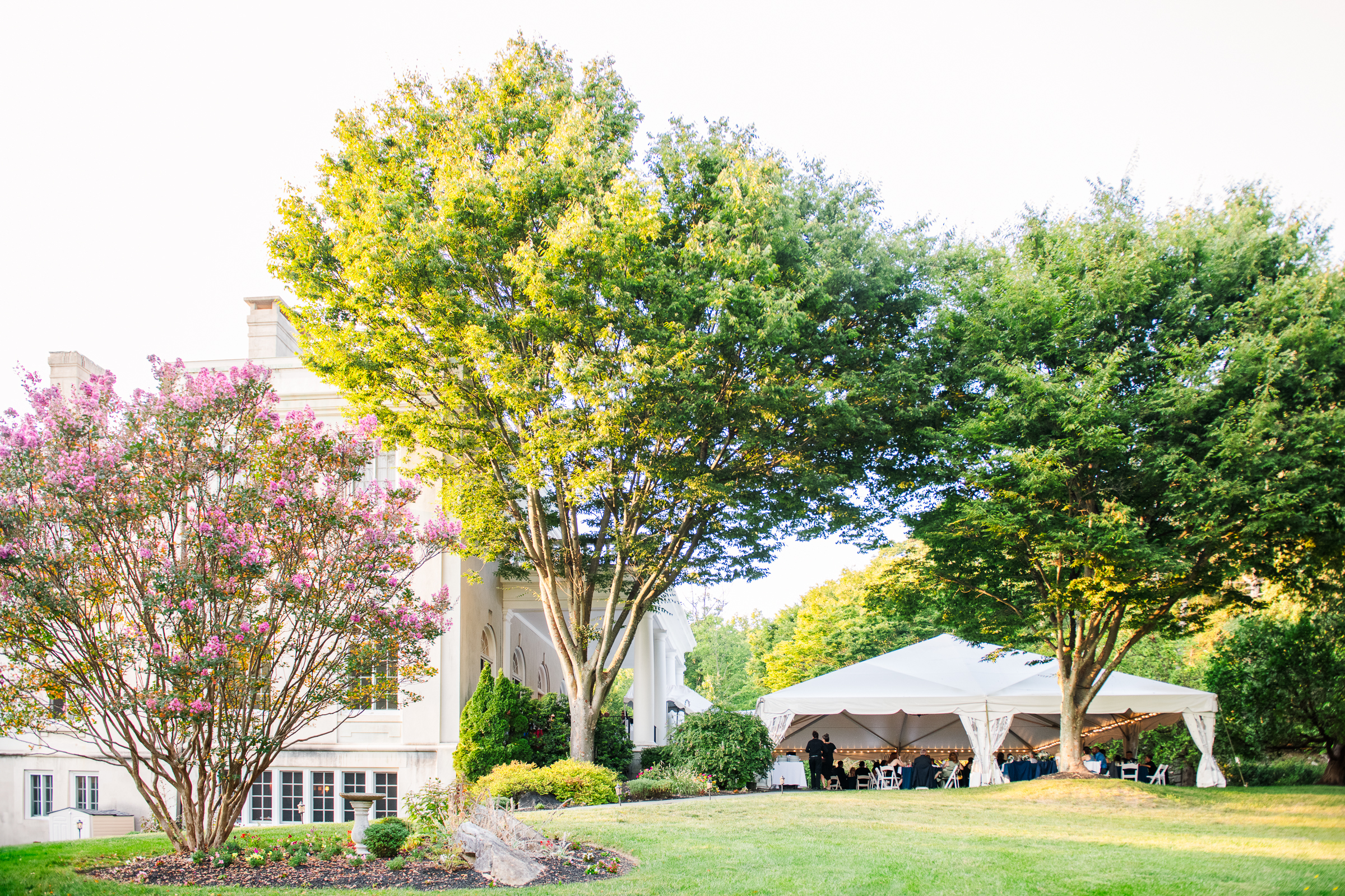 A wide-angle view of a luxury outdoor wedding reception tent at the historic Strong Mansion in Frederick, Maryland, photographed by Mary Sarah Photography.