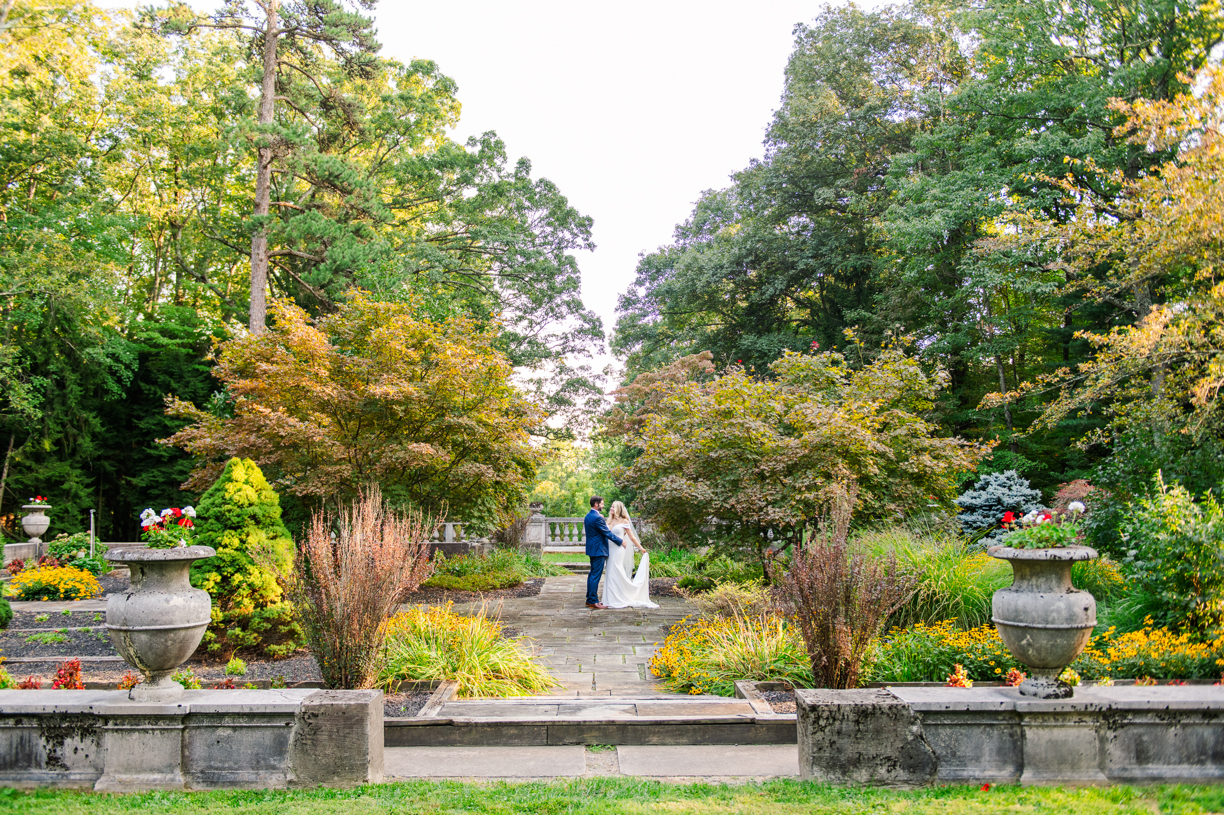 Bride and groom dancing in the formal gardens of Strong Mansion during a sunset portrait session by Mary Sarah Photography.
