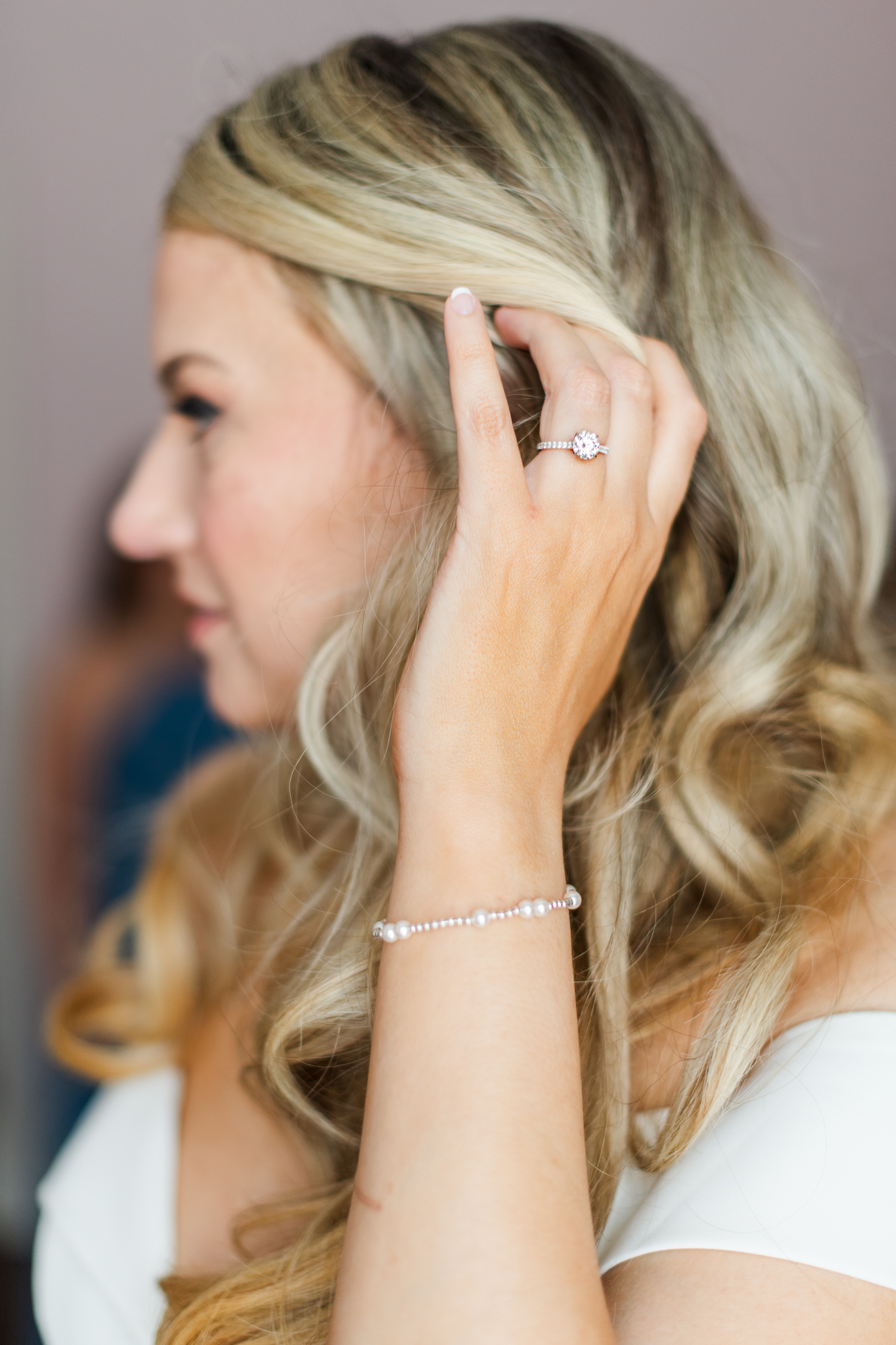 A luxury detail shot of a bride's ring as she tucks her hair behind her ear photographed by Loudoun Virginia Wedding photographer Mary Sarah Photography